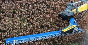 Close up image of the Slanetrac HC180L Excavator Mounted Hedge Attachment cutting a hedge